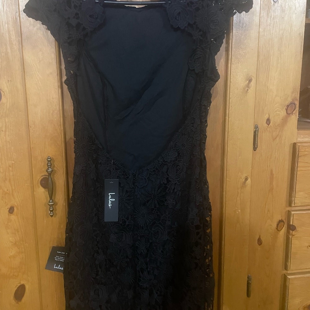Sexy cocktail dress with open back. Never worn but makes you feel sexy!